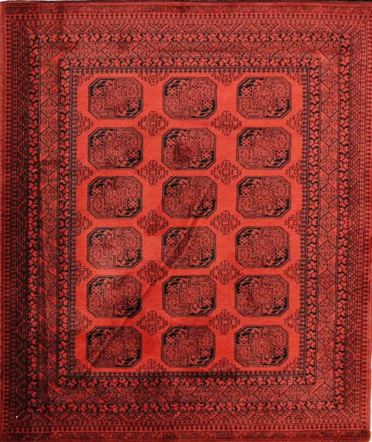 A rectangular, machine-made Afghan rug with a red and black geometric pattern.