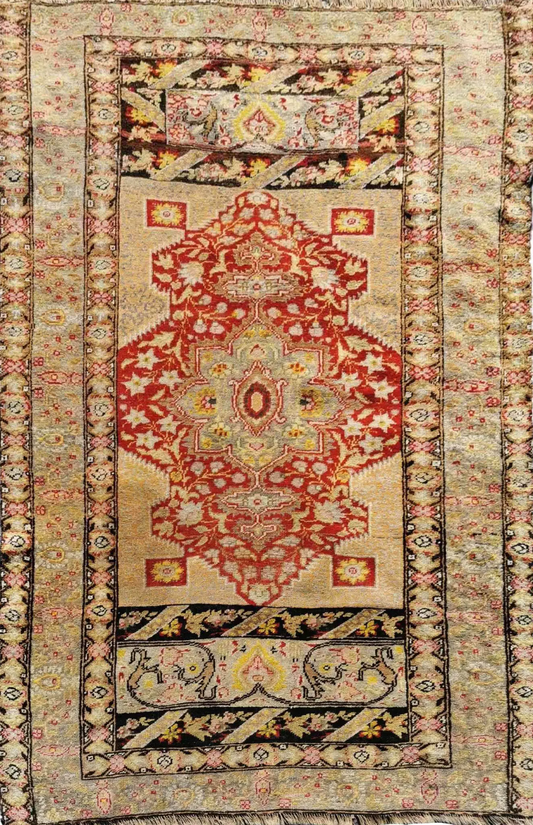 Antique Anatolian rug with a geometric pattern featuring brown and red colors, indicative of traditional rug weaving techniques.