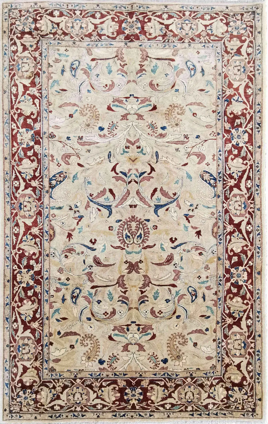 A Ziegler wool rug with a beige background and red secondary accents, featuring floral motifs and intricate borders.