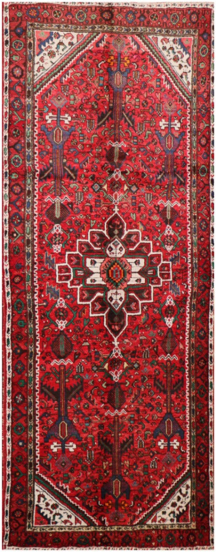 A long, rectangular, red wool rug