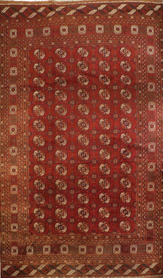 A red and beige colored Afghan wool rug
