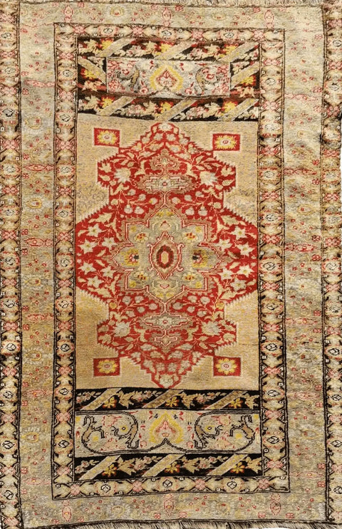 Antique Anatolian rug with a geometric pattern featuring brown and red colors, indicative of traditional rug weaving techniques.