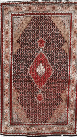A traditional wool rug with a geometric 'Mahi' fish pattern in red and blue colors, and a border in a lighter shade.