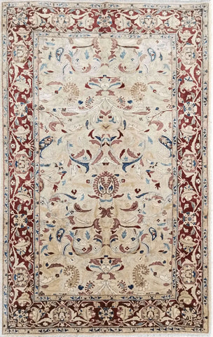 A Ziegler wool rug with a beige background and red secondary accents, featuring floral motifs and intricate borders.