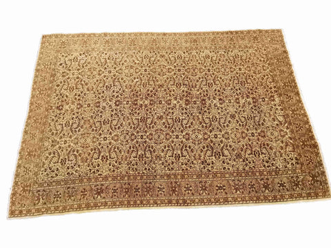 A beige and brown colored wool rug with a traditional geometric pattern.
