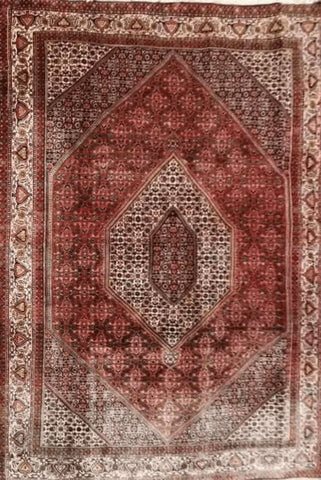 A Persian Bidjar red rug with a central medallion and geometric patterns
