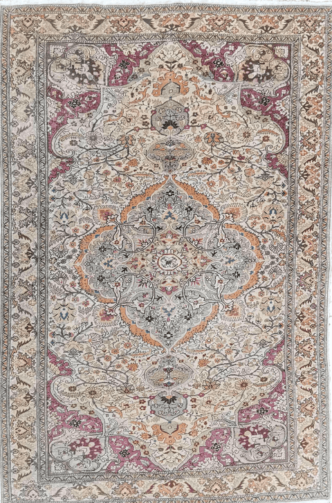 A large rectangular Anatolian rug with a red background and pink secondary accents, featuring intricate geometric and floral motifs.