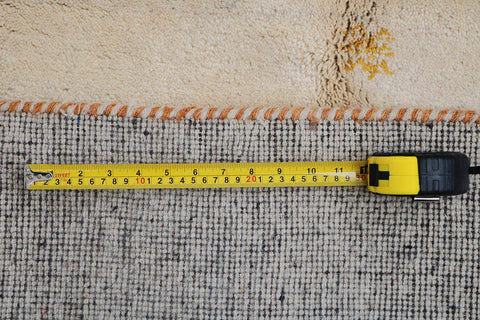 A cream and beige colored Gabbeh Tribal wool rug
