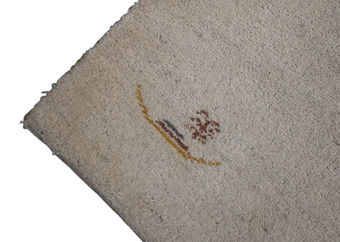A cream and beige colored Gabbeh Tribal wool rug