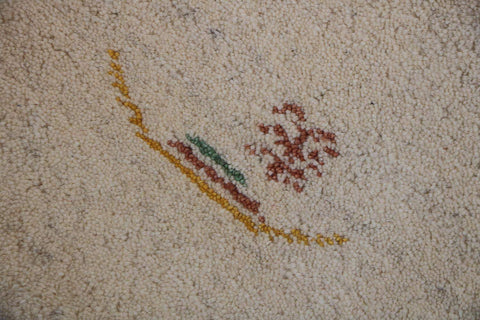 A cream and beige colored Gabbeh Tribal wool rug