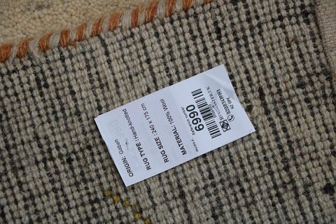A cream and beige colored Gabbeh Tribal wool rug
