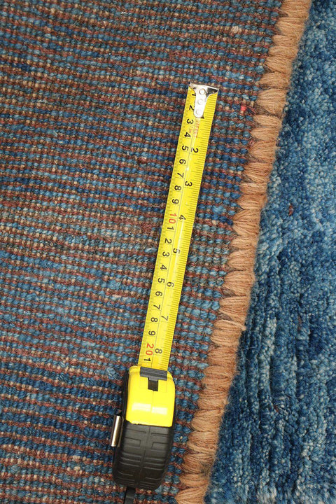 A vertical image of a Gabbeh Runner Tribal Wool Rug
