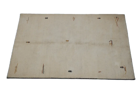 Gabbeh Tribal Wool Rug with a primarily cream color and small beige patterns throughout.