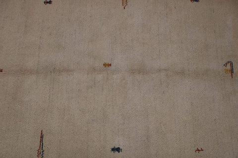 Gabbeh Tribal Wool Rug with a primarily cream color and small beige patterns throughout.