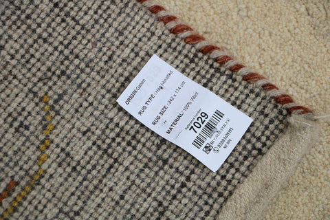Gabbeh Tribal Wool Rug with a primarily cream color and small beige patterns throughout.