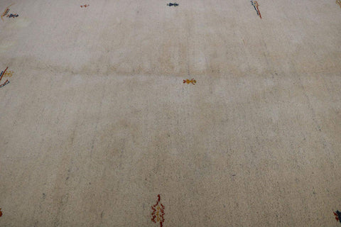Gabbeh Tribal Wool Rug with a primarily cream color and small beige patterns throughout.