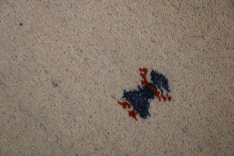 Gabbeh Tribal Wool Rug with a primarily cream color and small beige patterns throughout.