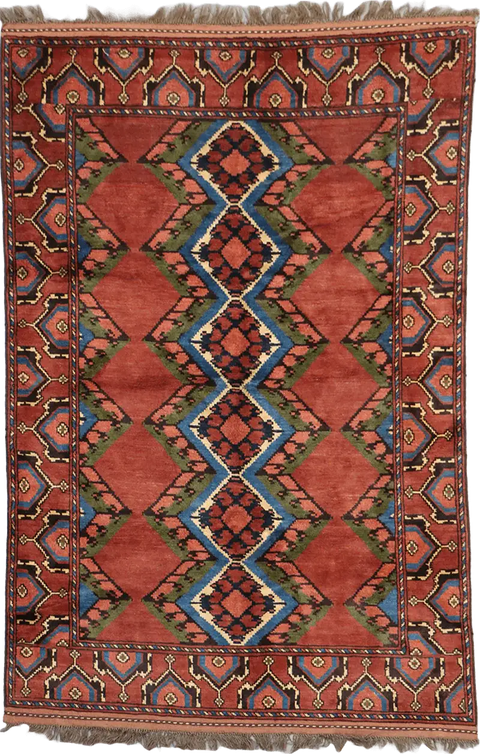 A geometric patterned Afghan Tribal Wool Rug in beige, red, and other colors.