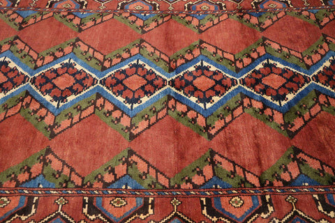 A geometric patterned Afghan Tribal Wool Rug in beige, red, and other colors.