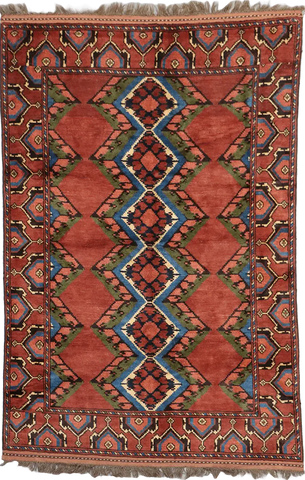 A geometric patterned Afghan Tribal Wool Rug in beige, red, and other colors.
