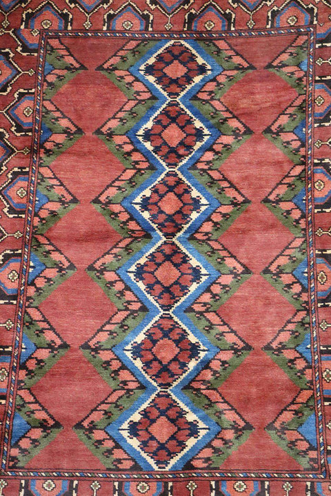 A geometric patterned Afghan Tribal Wool Rug in beige, red, and other colors.