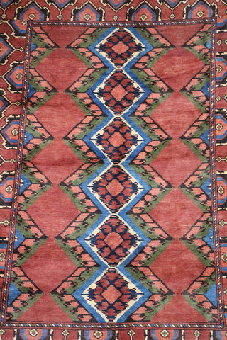A geometric patterned Afghan Tribal Wool Rug in beige, red, and other colors.