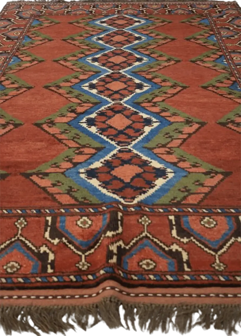 A geometric patterned Afghan Tribal Wool Rug in beige, red, and other colors.
