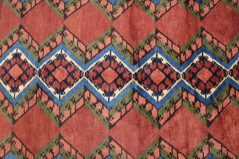 A geometric patterned Afghan Tribal Wool Rug in beige, red, and other colors.
