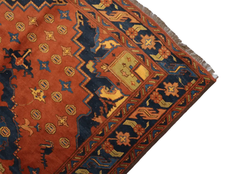 A vibrant orange and blue geometric-patterned wool rug