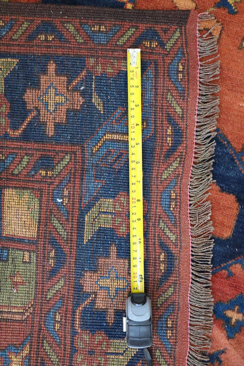 A vibrant orange and blue geometric-patterned wool rug