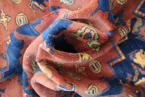 A vibrant orange and blue geometric-patterned wool rug