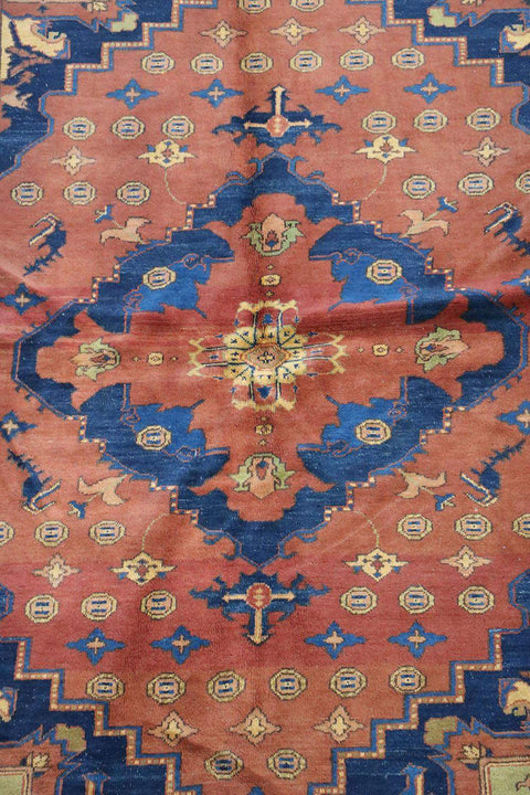 A vibrant orange and blue geometric-patterned wool rug