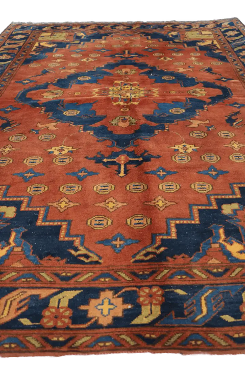 A vibrant orange and blue geometric-patterned wool rug