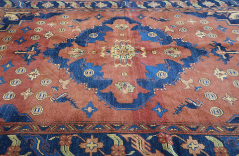 A vibrant orange and blue geometric-patterned wool rug