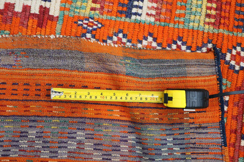 A vibrant orange and multicolored Berber tribal wool rug