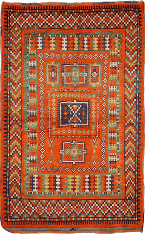 A vibrant orange and multicolored Berber tribal wool rug