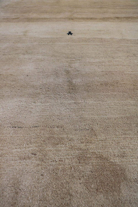 A beige and cream Persian Gabbeh Tribal Rug