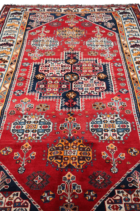 A vibrant red Persian Qashqai tribal rug