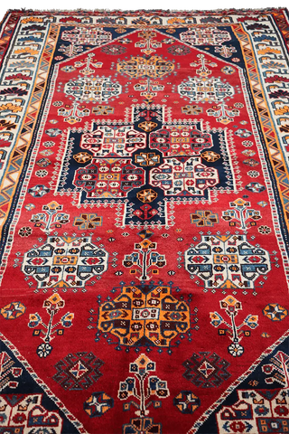 A vibrant red Persian Qashqai tribal rug