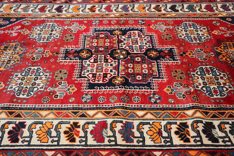 A vibrant red Persian Qashqai tribal rug