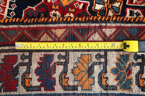 A vibrant red Persian Qashqai tribal rug