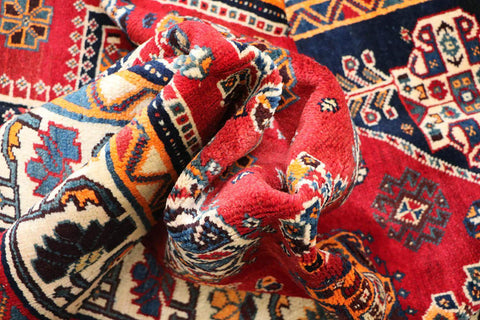 A vibrant red Persian Qashqai tribal rug