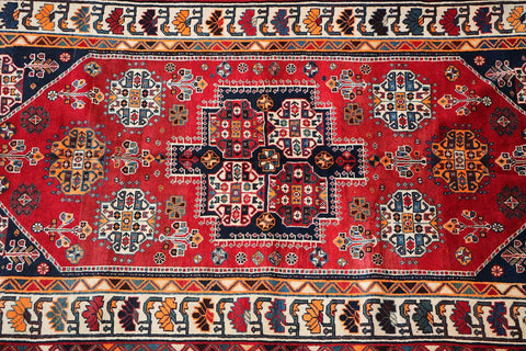 A vibrant red Persian Qashqai tribal rug