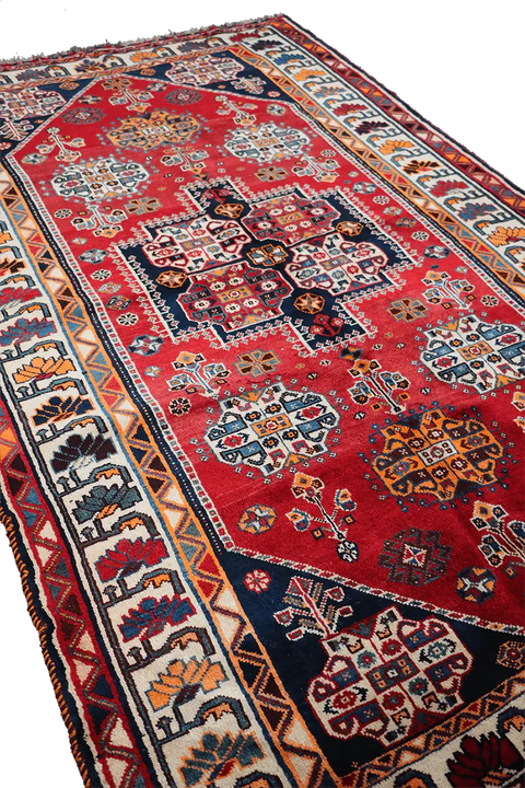 A vibrant red Persian Qashqai tribal rug