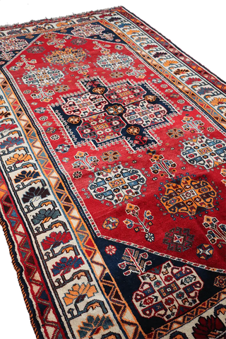 A vibrant red Persian Qashqai tribal rug