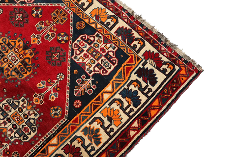 A vibrant red Persian Qashqai tribal rug