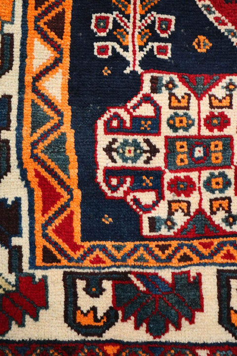 A vibrant red Persian Qashqai tribal rug