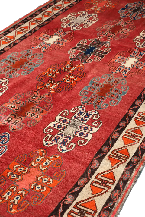 A vertical image of a Persian Qashqai Tribal Rug 