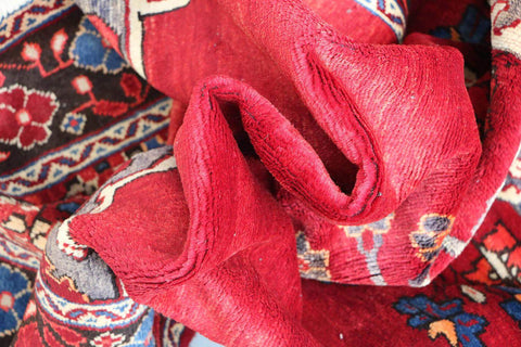 A vibrant red wool rug