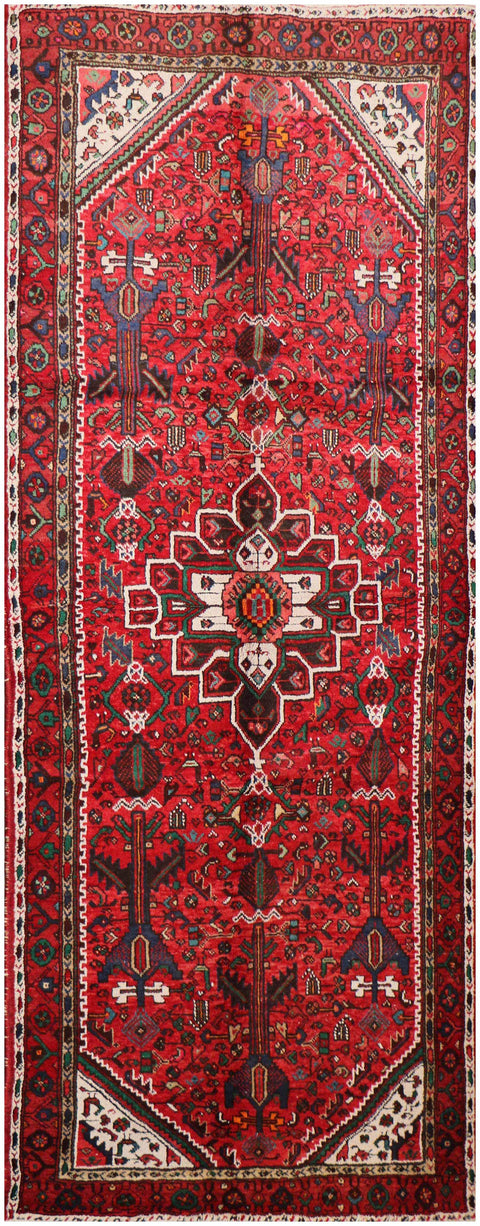 A long, rectangular, red wool rug 